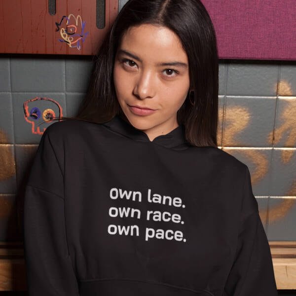 A stylish black women's crop hoodie with the motivational text "Own Lane. Own Race. Own Pace." Perfect for casual wear and athleisure, empowering women to embrace individuality.