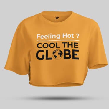 A woman wearing a beige crop top with the text "Feeling Hot? Cool the Globe" printed in bold, black and white letters. The t-shirt promotes climate awareness in a trendy, casual style.