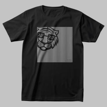 A black oversized t-shirt featuring a glitch-style tiger face with XO eyes, printed on a fine-line gradient background. A Kloch Exclusive streetwear essential.
