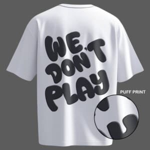 Oversized white streetwear t-shirt featuring 3D puff print "We Don’t Play" text – a bold and stylish must-have for urban fashion lovers.
