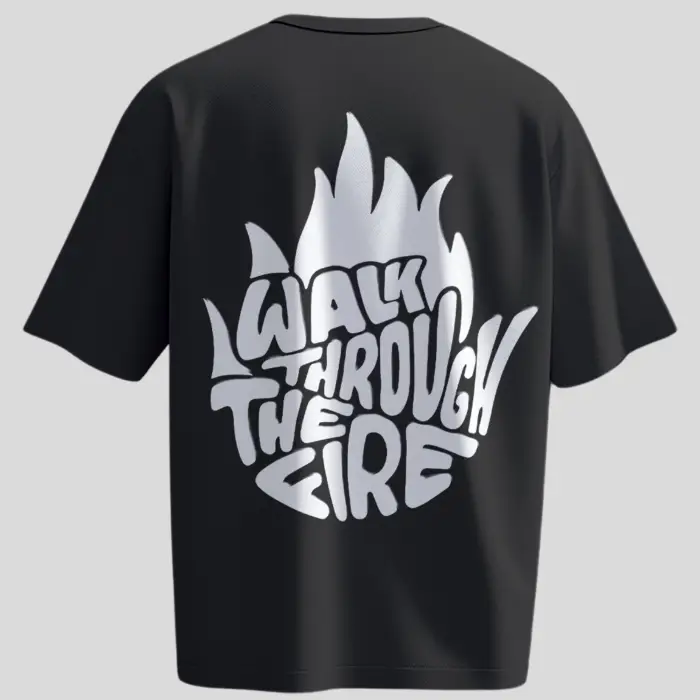 Back view of black oversized unisex t-shirt with bold white flame-shaped graphic text “Walk Through The Fire” – motivational streetwear by Kloch.