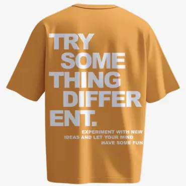 Mustard yellow t-shirt with bold white typography reading “Try Something Different” – motivational back print