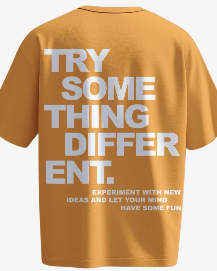 Mustard yellow t-shirt with bold white typography reading “Try Something Different” – motivational back print