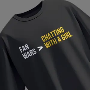 Black oversized t-shirt with "Fan Wars > Chatting with a Girl" printed in white and yellow, inspired by actor Sree Vishnu.
