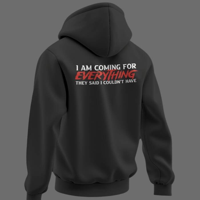 Black oversized hoodie with bold quote on back reading “I AM COMING FOR EVERYTHING THEY SAID I COULDN’T HAVE” in white and red typography.