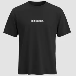 Black t-shirt with bold white uppercase text “ON A MISSION.” printed on the chest